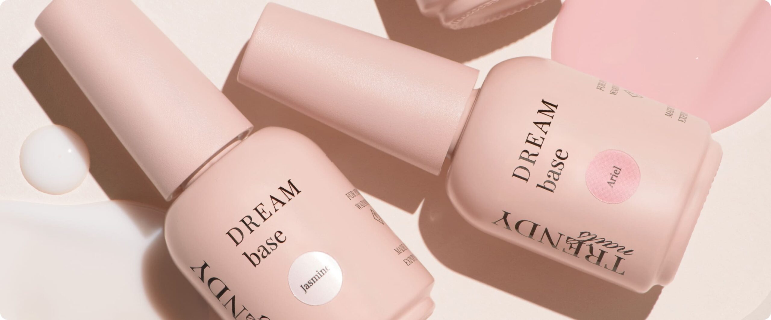 Trendy Nails DREAM base bottles in soft pink tones with labels, accompanied by text promoting new products